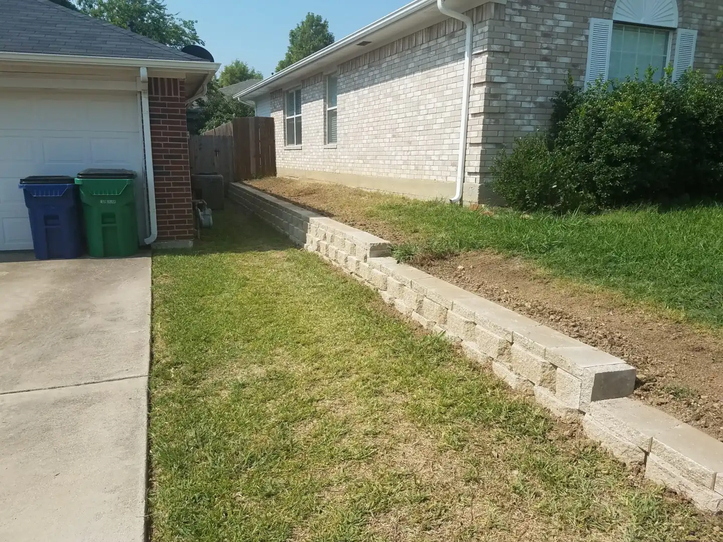 Concrete block retaining wall stabilizing a sloped front yard in Colleyville, TX Concrete block retaining wall stabilizing a sloped front yard in Colleyville, TX
