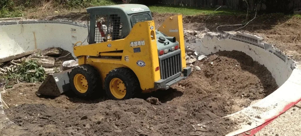 Skid steer backfilling a removed pool during demolition in Colleyville, TX Skid steer backfilling a removed pool during demolition in Colleyville, TX